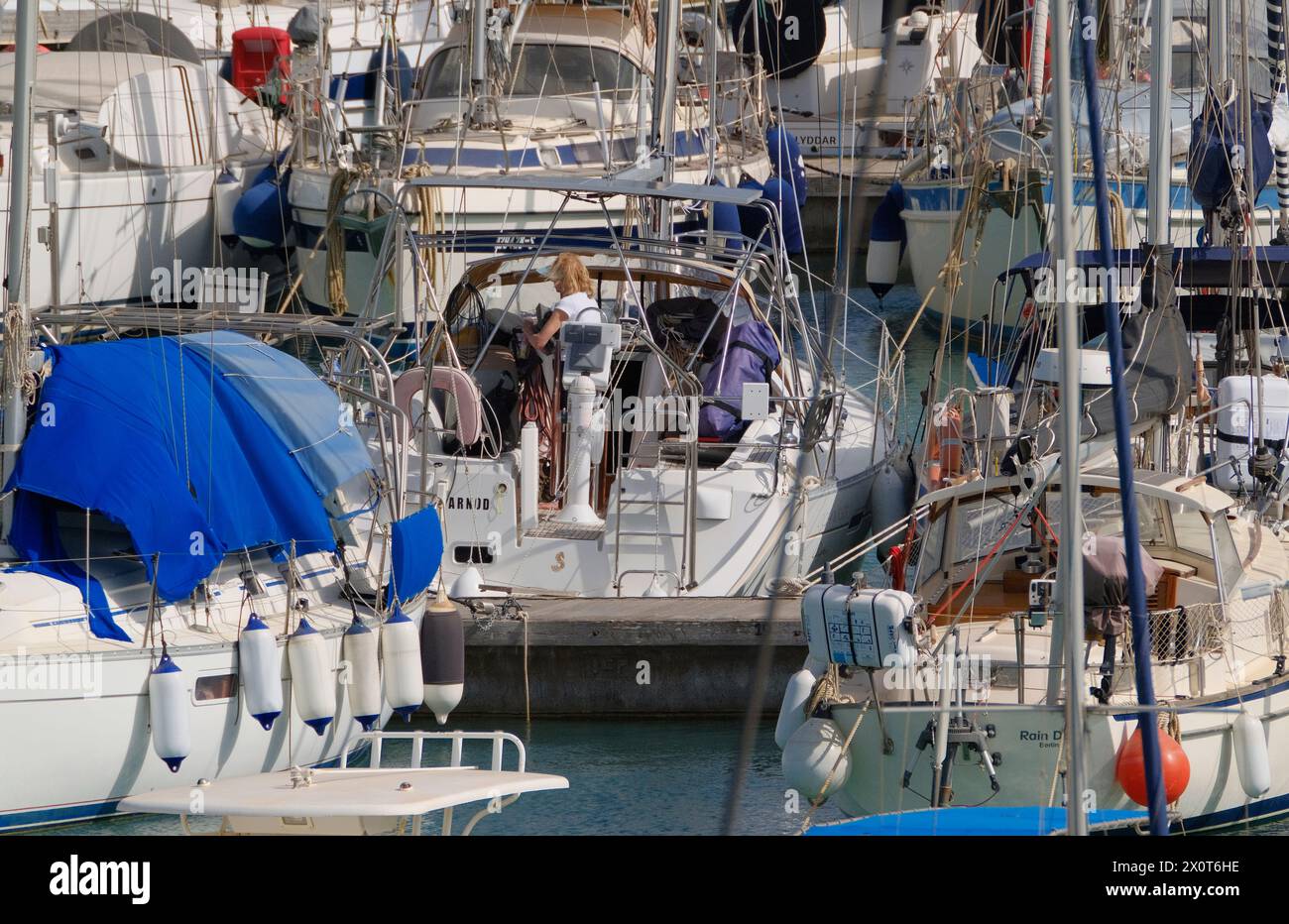 Italien, Sizilien, Mittelmeer, Marina di Ragusa (Provinz Ragusa); 13. April 2024, Frau auf einem Segelboot im Hafen - EDITORIAL Stockfoto