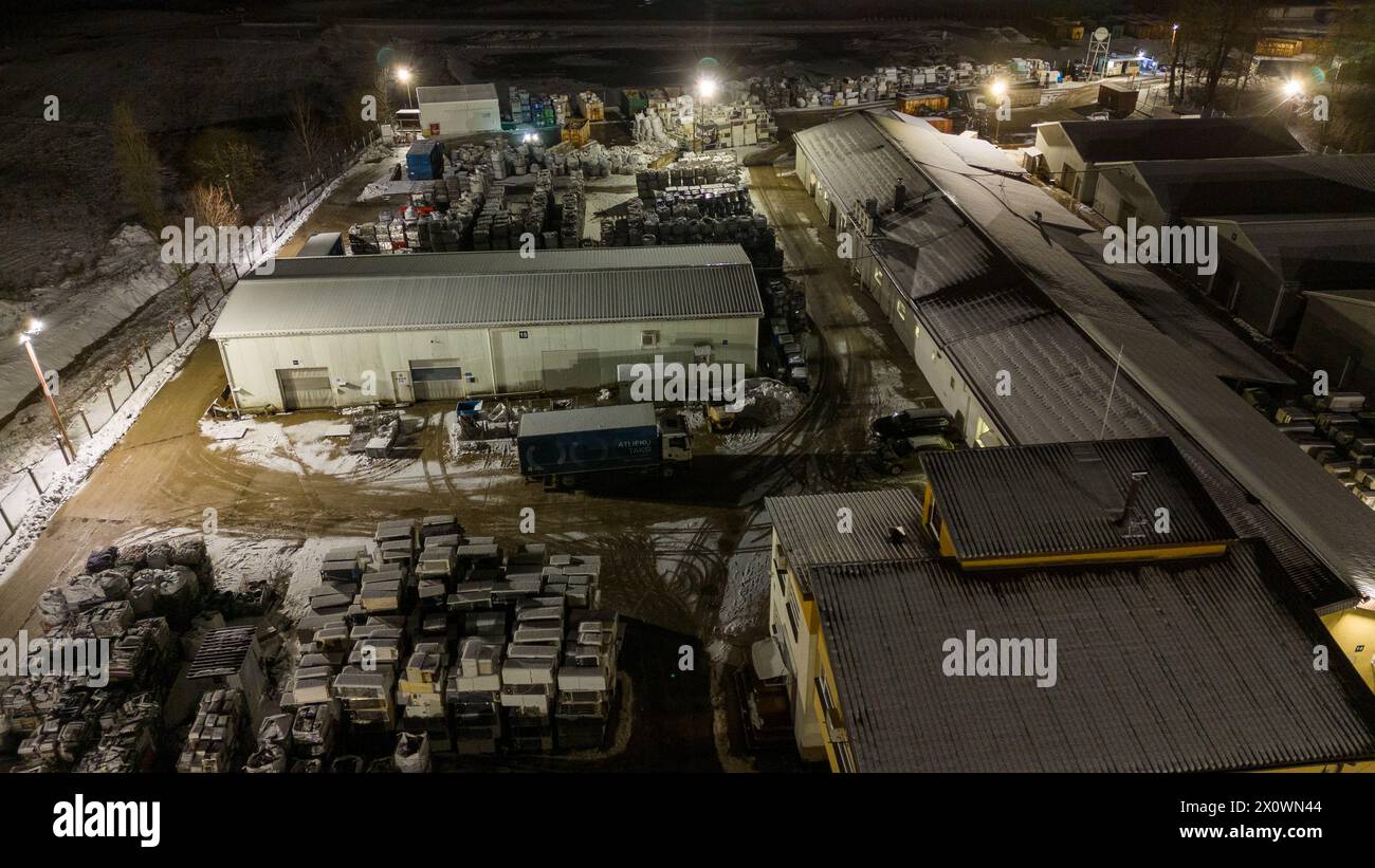 Drohnenfotografie von Metall-Recycling-Anlagen in der Nacht und Metallhaufen in der winterlichen bewölkten Nacht Stockfoto