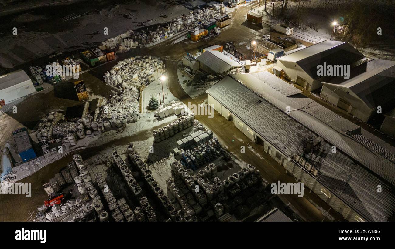 Drohnenfotografie von Metall-Recycling-Anlagen in der Nacht und Metallhaufen in der winterlichen bewölkten Nacht Stockfoto