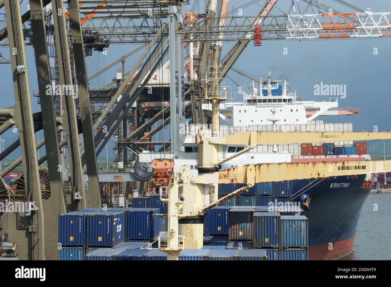 Frachtbetrieb im Containerterminal im Hafen von Kingston, wo verschiedene Schiffe entladen und mit Portalkranen beladen werden. Stockfoto