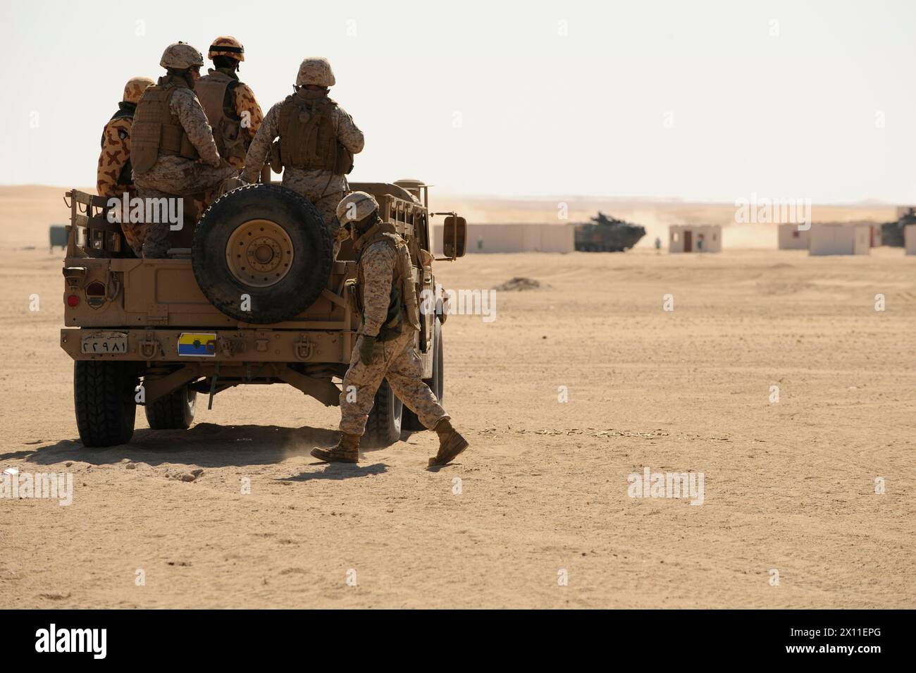 Marines von der 26. Marine Expeditionary Unit und Mitglieder der kuwaitischen Streitkräfte sorgen für Deckfeuer aus dem Militärfahrzeug der Gastgebernation während einer Theaterunterstützungskooperation Live-Feuerübung ca. Januar 2004 oder (2009 pro Metadaten) Stockfoto