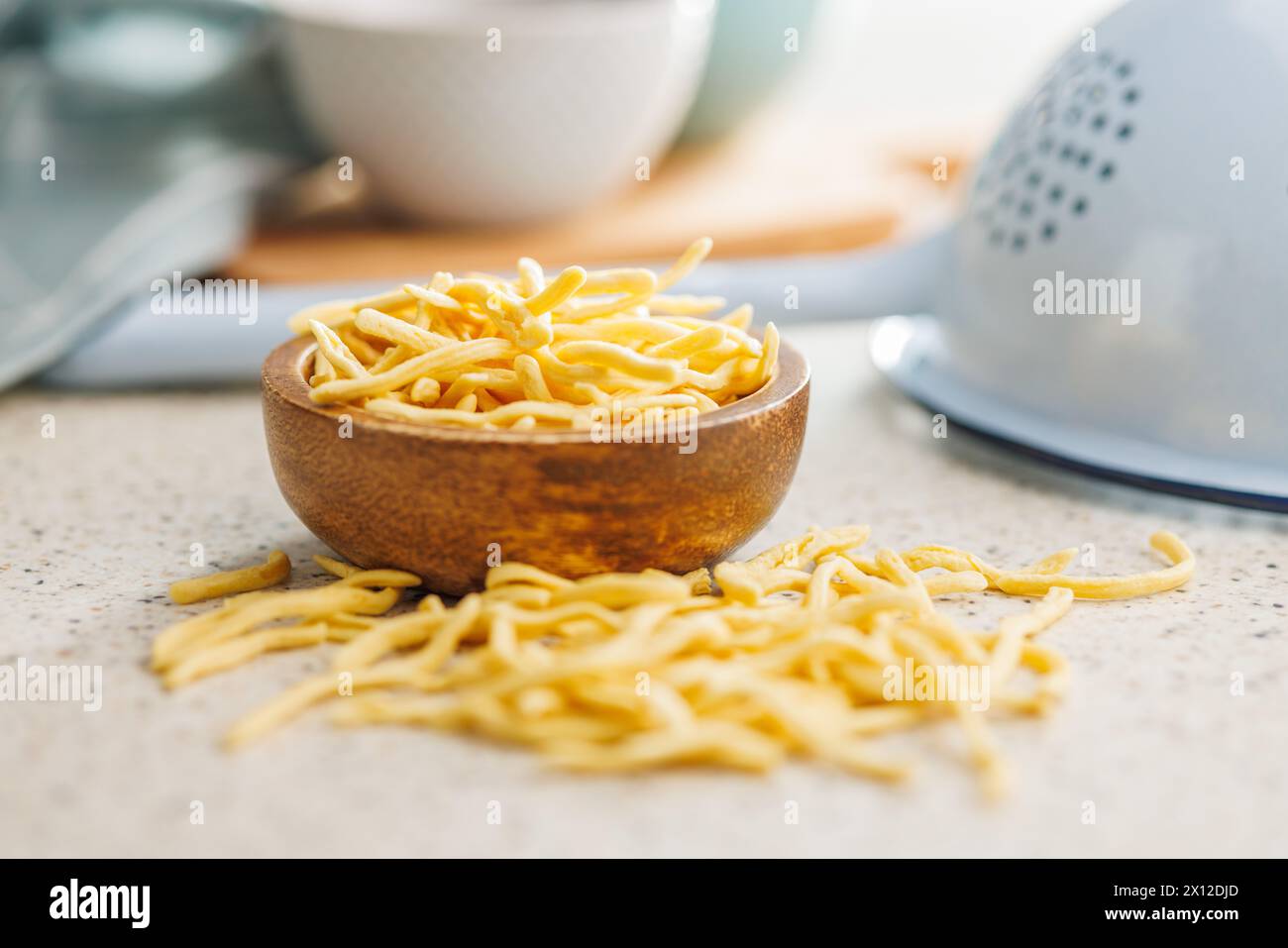 Ungekochte Spätzle Nudeln in einer Schüssel auf einem Küchentisch. Stockfoto