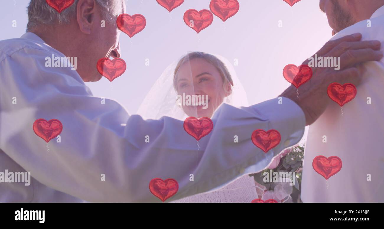Bild von roten Herzen über glückliches kaukasisches Paar und männlichen Ehebeamten am Hochzeitstag Stockfoto