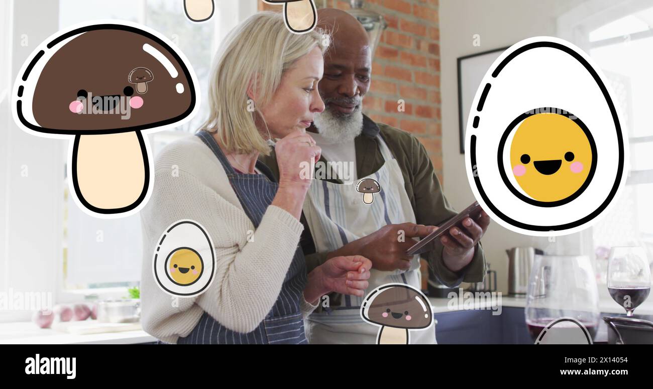 Bild von Lebensmittelsymbolen über verschiedenen Paaren, die Tablets in der Küche verwenden Stockfoto