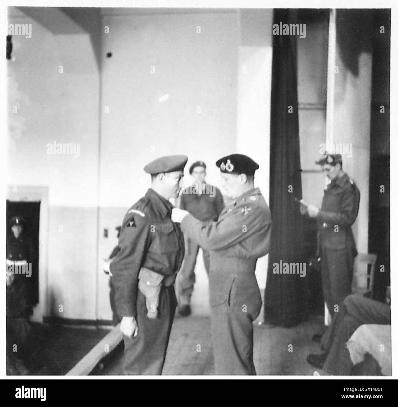 Major F. Bell vom 2. Warwickshire-Regiment erhält das Militärkreuz während einer Einsetzung im Gimers Monastery, 3. Britische Division, 21. Armeegruppe. Stockfoto