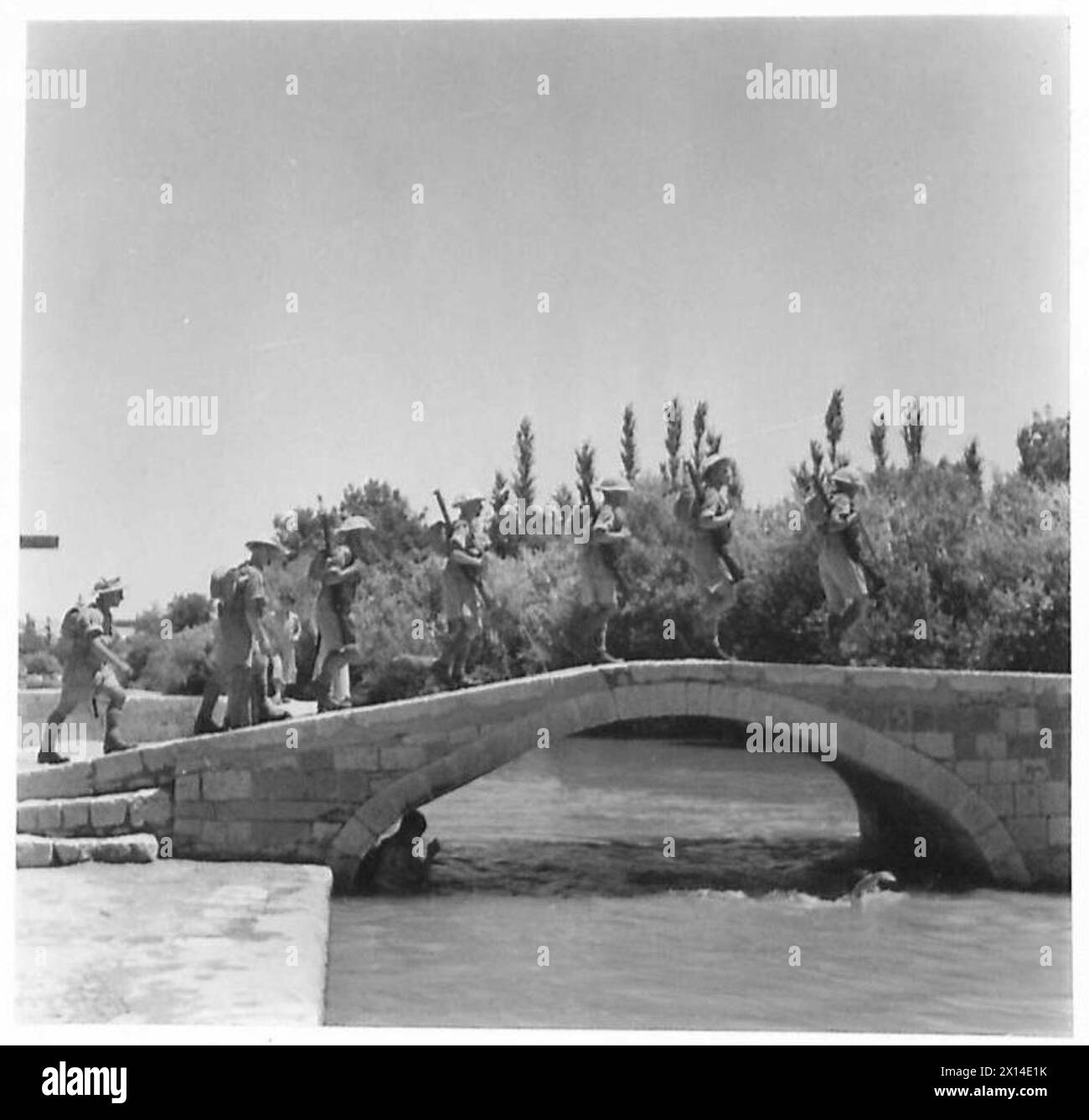 Foto: Britische Truppen marschieren über eine kleine Brücke in einer syrischen Stadt zusammen mit französischen Truppen während militärischer Operationen, britische Armee. Stockfoto