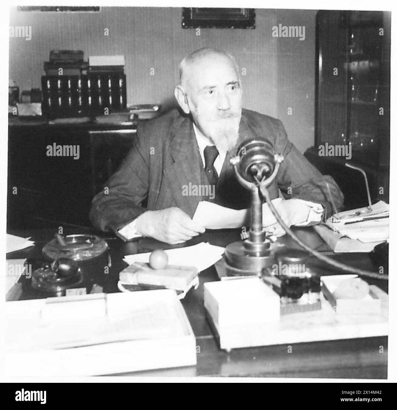 Dr. Karl Renner, Chef der österreichischen Landesregierung, nimmt eine Rede vor der britischen Öffentlichkeit in seinem Haus in Wien auf, wobei der BBC-Techniker Patrick Smith die Aufnahme übernimmt. Stockfoto