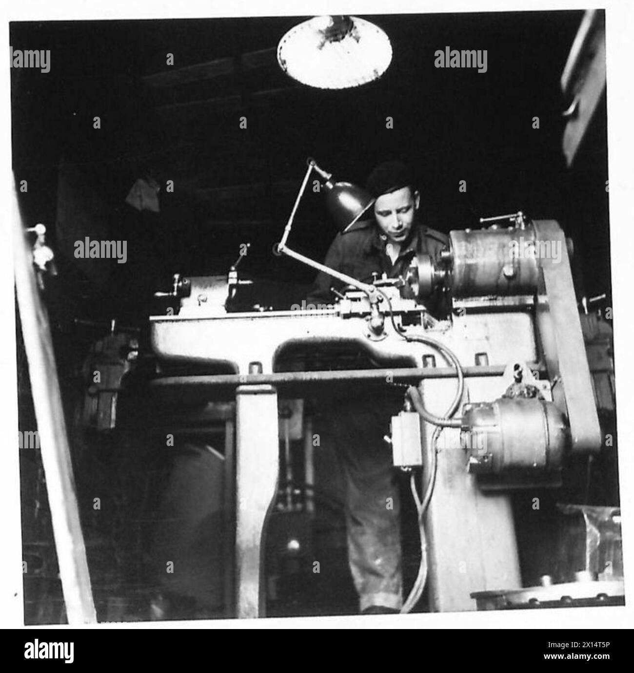 Korporal Koole von der R.E.M.E. arbeitet an einer Werkzeugmaschinendrehmaschine in einer LKW-Werkstatt in Tunesien. Stockfoto