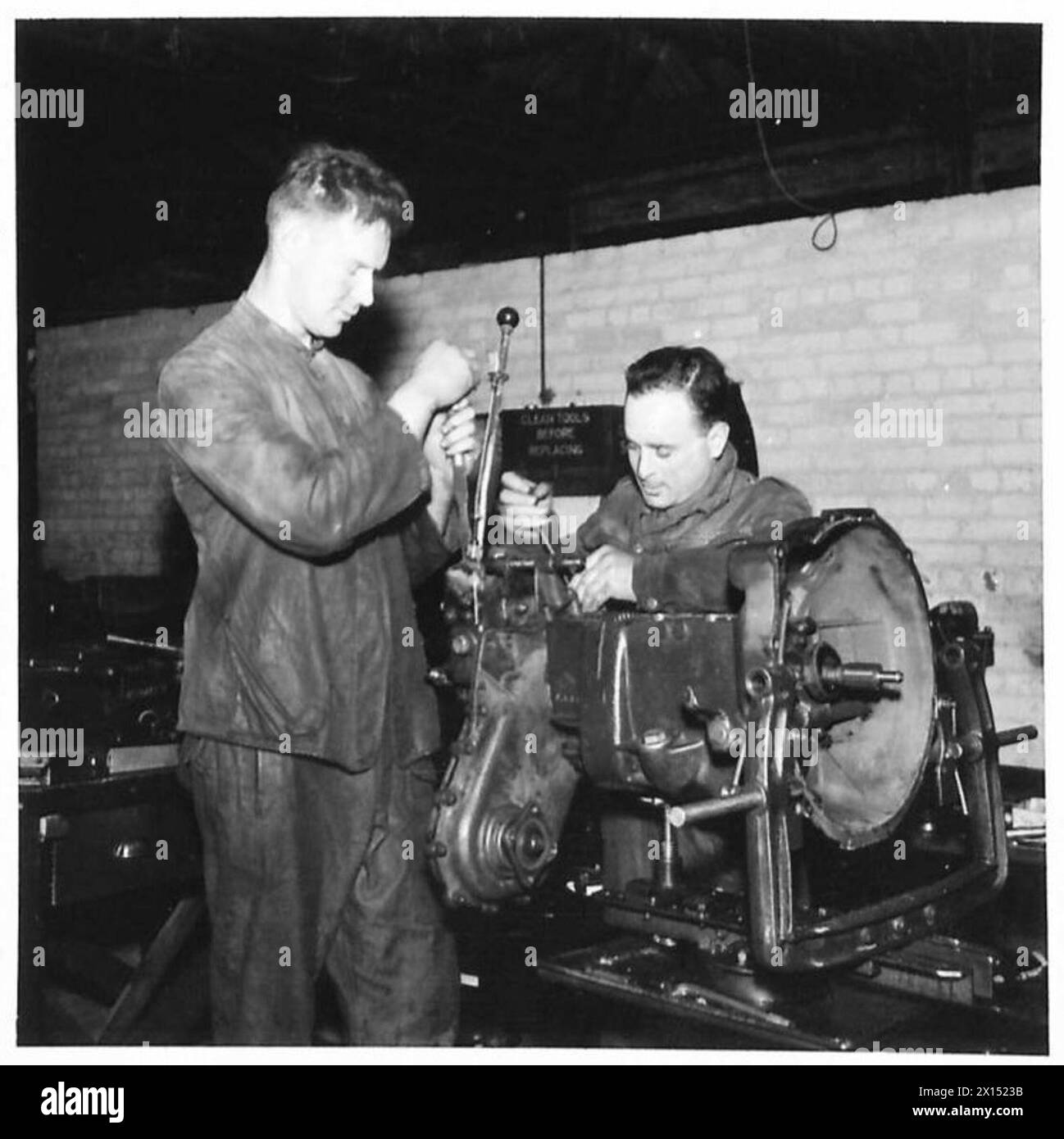 Mitarbeiter der Royal Electrical and Mechanical Engineers, die einen Motor reparieren, darunter der Craftsman J. Stacey und der Craftsman Toshner, die die mechanischen Wartungsaufgaben in der britischen Armee veranschaulichen. Stockfoto