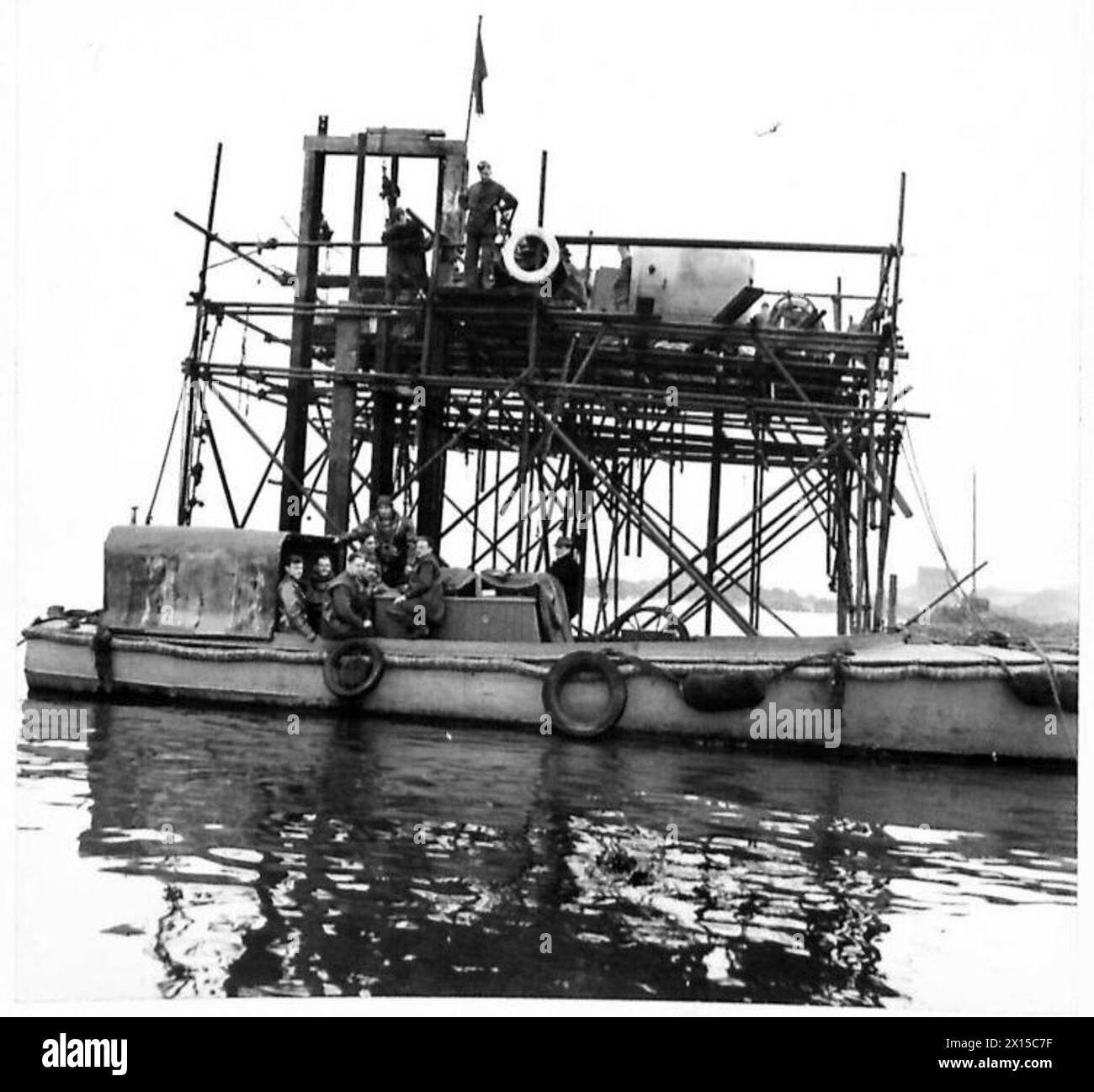 Taucher operieren von einem Boot- und Pier-Gerüst aus in einer Unterwasser-Armee-Übung, die durch eine funktionierende Flagge gekennzeichnet ist. Stockfoto