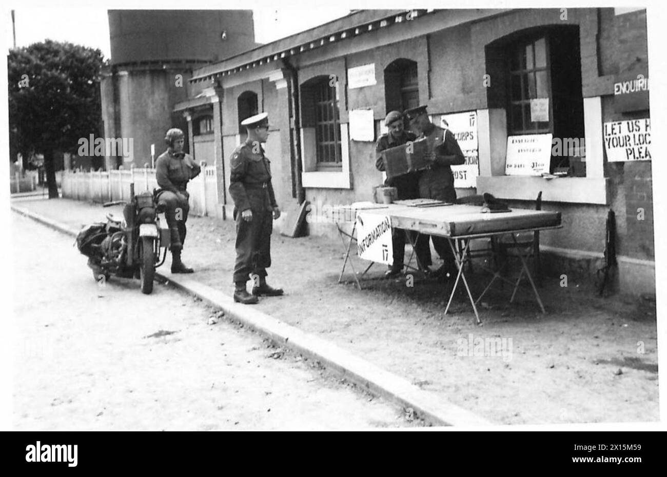 DIE MILITÄRPOLIZEI NUTZT DIE BAYEUX-STATION, Eine Szene im Bayeux-Bahnhofshof, die heute von der Militärpolizei als Informationsbüro genutzt wird. L/Corporal F. Everard von 46 Market Hill, Malden, Essex, und Corporal A. Thomson von 52 Valley Road, London, SW16. Fahrzeug der 4. A/Brigade aufgestellt. 113. Provost Coy, britische Armee, 21. Armeegruppe Stockfoto