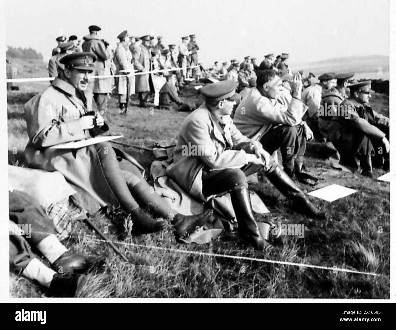 Hochrangige Armeekommandanten, darunter alliierte Generäle, beobachten einen Scheinkampf während eines Trainingskurses zu Hause. Zu den Offizieren gehören Generalleutnant J.D. des R. Swayne, General Wekkes und Generalleutnant McNaughton. Die britische Armee ist anwesend. Stockfoto
