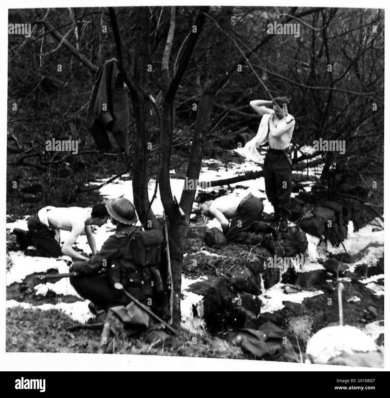 Soldaten waschen sich an einem eiskalten Gebirgsbach, während sie unter Feldbedingungen eingesetzt werden, Teil der Operationen der British Army. Stockfoto