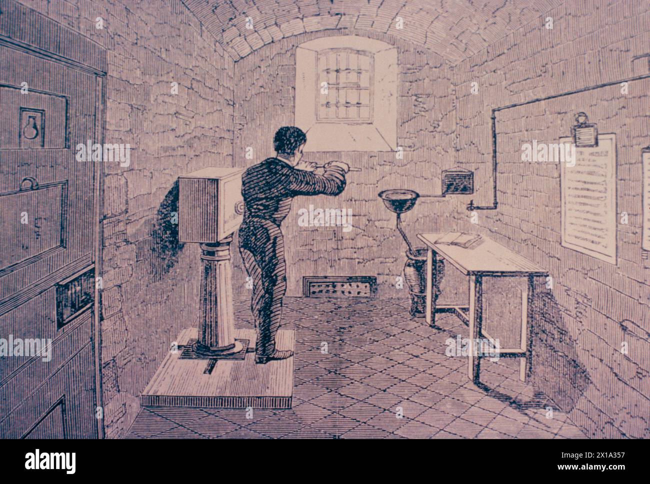 Eine Zelle mit einem Gefangenen bei Kurbeln im Surrey House of Correction, London, England 1862 Stockfoto