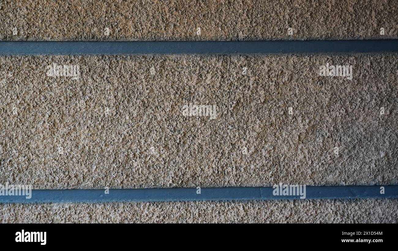 Die cremegelben Steinmauern mit schwarzen horizontalen Linien Stockfoto