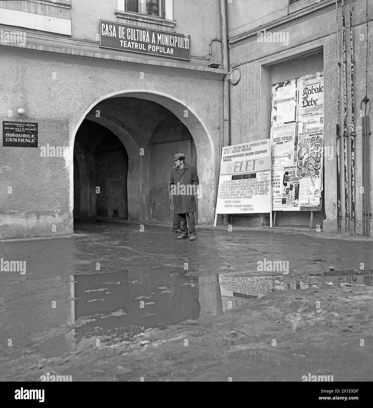 Medias, Kreis Sibiu, Sozialistische Republik Rumänien, ca. 1975. Schlammiger Bürgersteig vor einem lokalen Theater im historischen Zentrum. Stockfoto