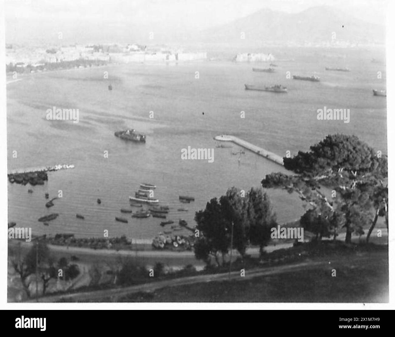 Im Januar 1944 versammeln US-Streitkräfte und Marineeskorte Truppenschiffe und Landungsboote für den Angriff auf die Gustav-Linie in der Nähe der Bucht von Neapel während der ersten Schlacht von Monte Cassino, wobei der Vesuv im Hintergrund sichtbar ist, die US-Armee und die US-Navy. Stockfoto