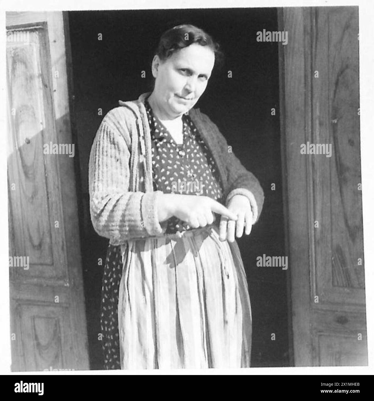 Signora Angela Montoferrante zeigt ihren Ringfinger und erzählt vom Diebstahl ihres Schmucks durch deutsche Streitkräfte, einschließlich Ringen, Armbändern, Ohrringen und Uhren. Britische Armee. Stockfoto