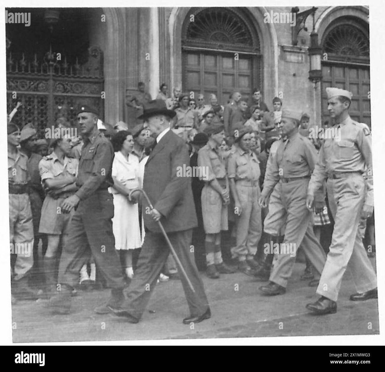 Britische Soldaten feiern die Unabhängigkeitserklärung in Rom, mit hochrangigen Offizieren wie Mr. Stimson, General Mark Clark und General J.L. Devers auf dem Paradegelände. Stockfoto