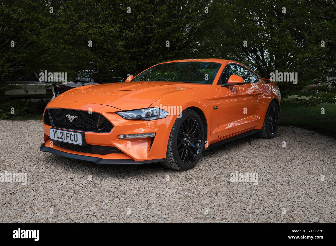 Orange Ford Mustang im April 2024 beim Banbury Car & Bike Meet im Banbury Cricket Club in Bodicote. Stockfoto