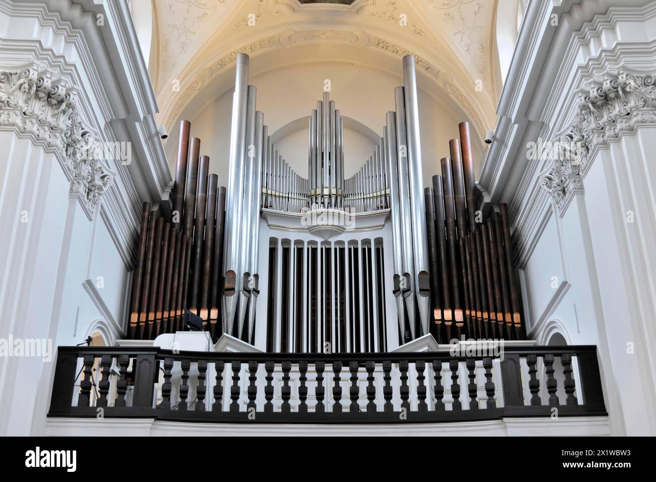 Die Orgel im Stiftskloster Neumünster, Würzburg, Nahaufnahme einer Orgel mit vielen Pfeifen und dekorativen Holzgeländern auf einem Balkon Stockfoto