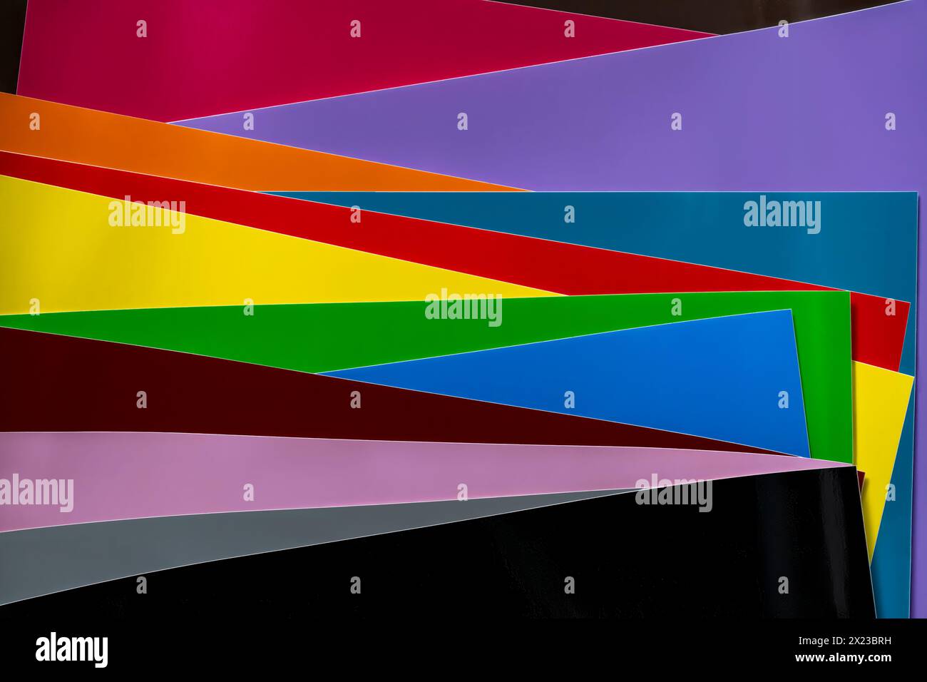Farbenfrohe Schichten aus verschiedenfarbigen Vinylfolien, die interessante geometrische Formen ergeben Stockfoto