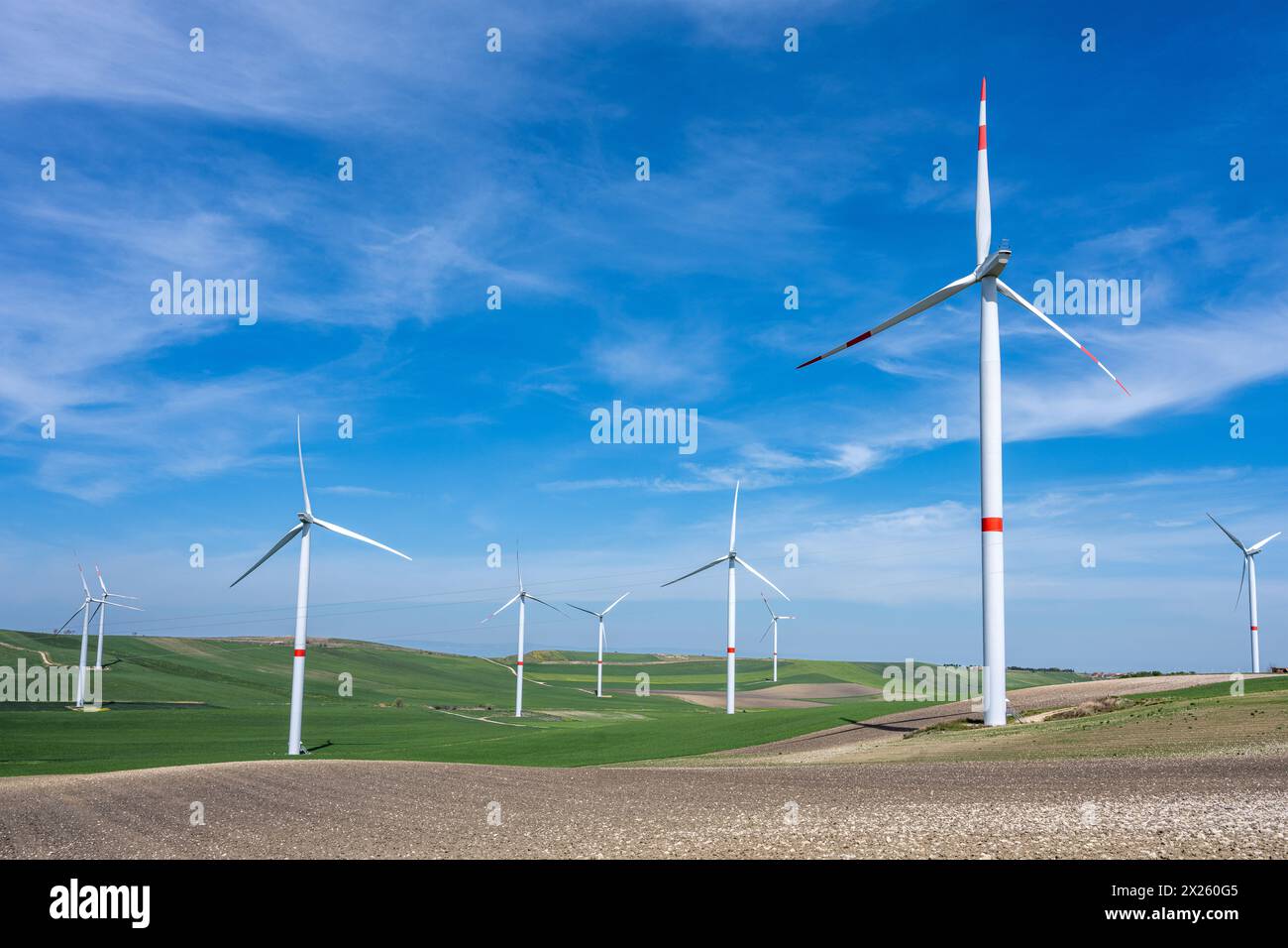 Windturbinen und grüne Agrarlandschaft in Süditalien Stockfoto