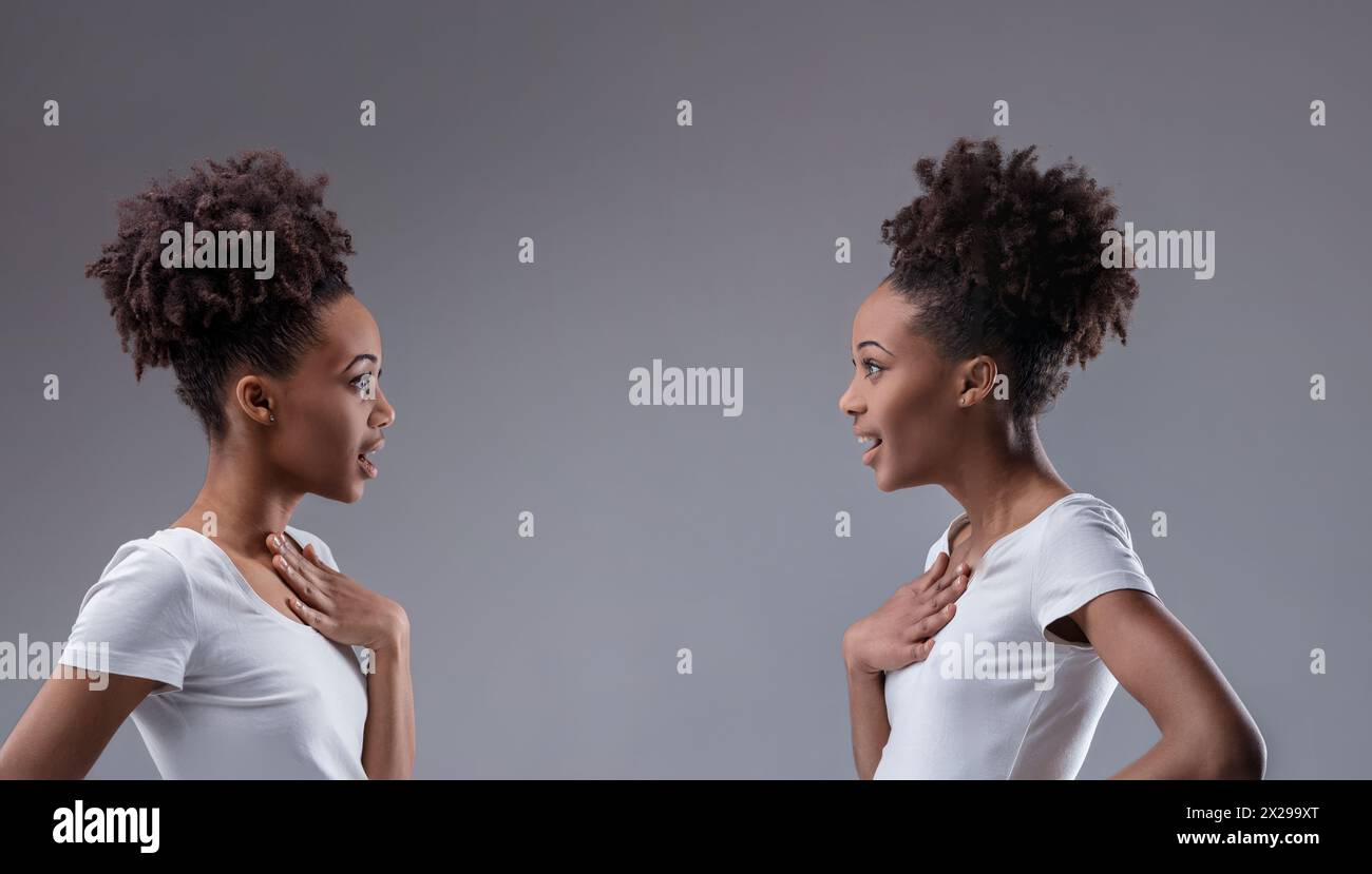 Überraschende Entdeckung des Gemeinsamkeitsgrundsatzes, der sich in den gespiegelten Ausdrücken zweier schwarzer Frauen zeigt Stockfoto