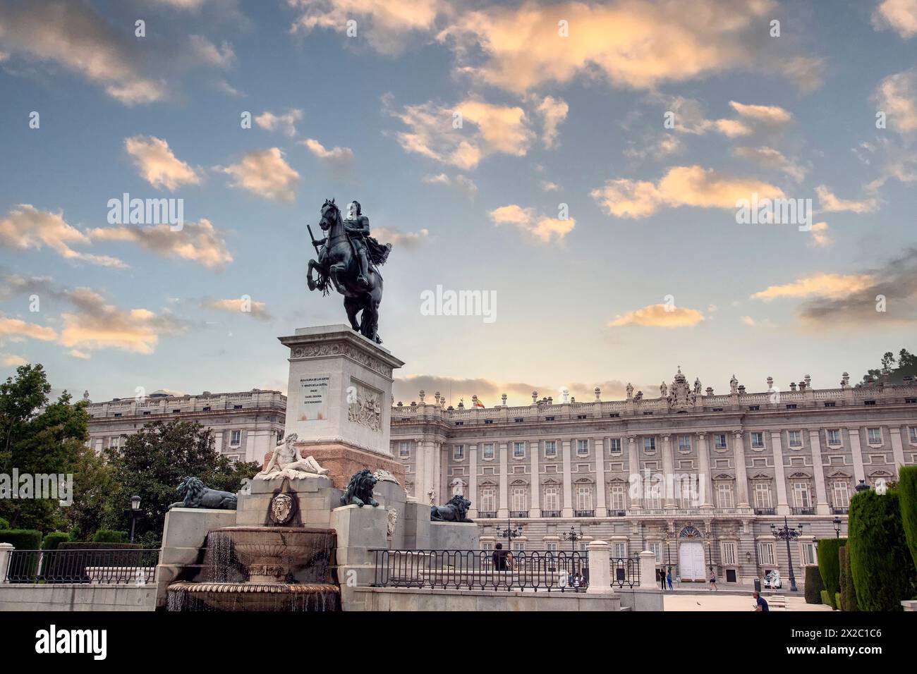 Königlicher Palast von Madrid an einem herrlichen Nachmittag, vom Oriente-Platz aus gesehen, mit der Statue des Königs Philipp IV. Im Vordergrund. Stockfoto