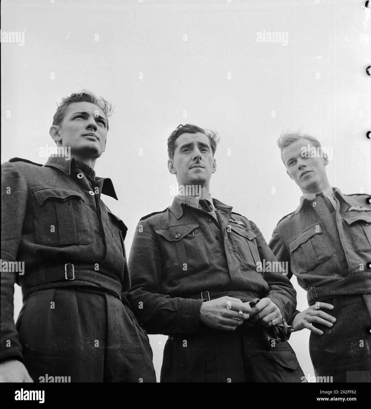 Squadron Leader W B Williams DFC, der einzige Engländer in No. 121 Eagle Squadron, ist mit Flight Lieutenant Jim Daly DFC aus Texas und Flight Lieutenant S R Edner aus Kalifornien, United States Army Air Forces in Großbritannien, 1942–1945 abgebildet. Stockfoto