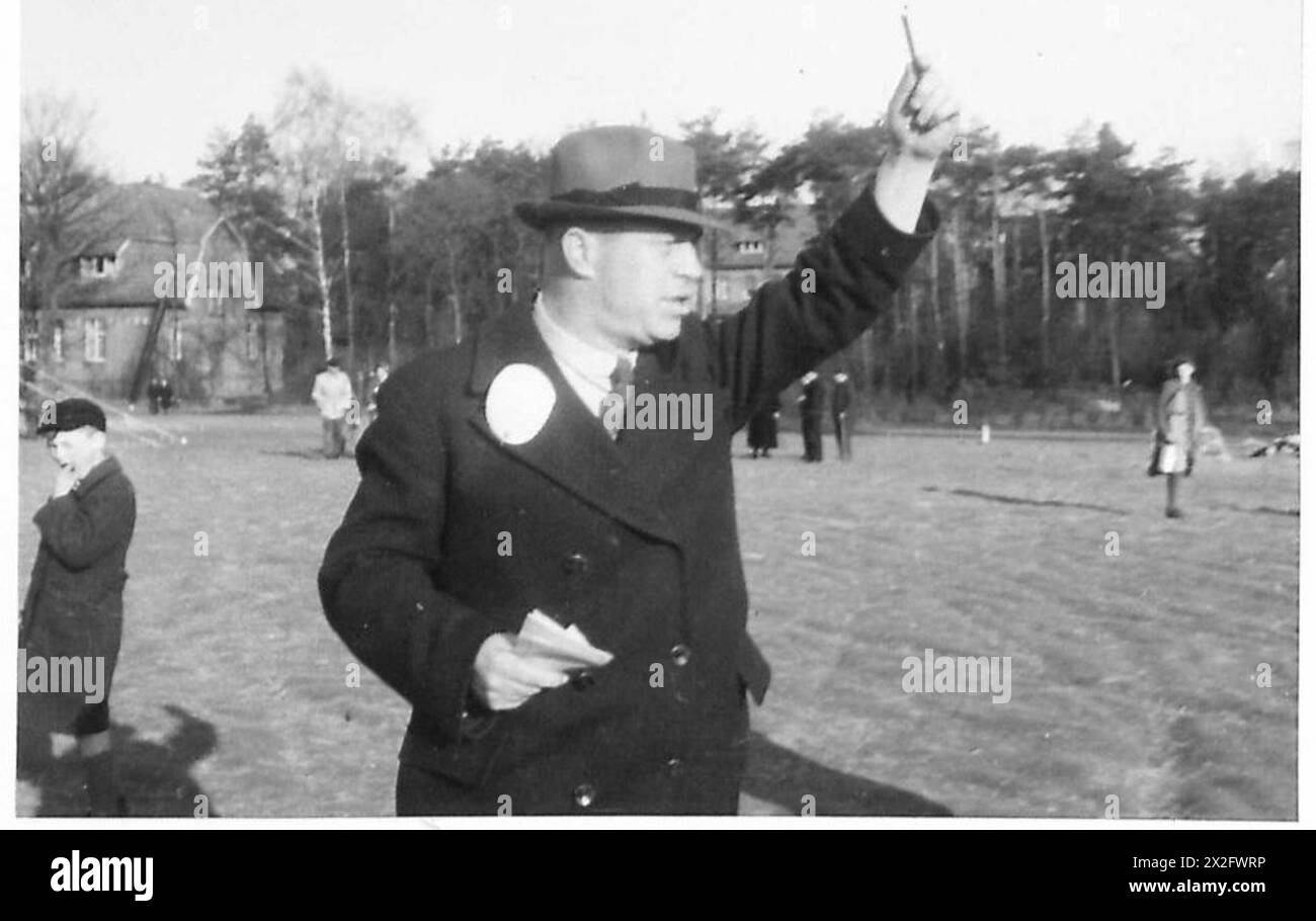 Ein deutscher Beamter erteilt Befehle unter der Aufsicht der britischen Militärregierung im Gebiet der 21. Armee während des Zweiten Weltkriegs Stockfoto