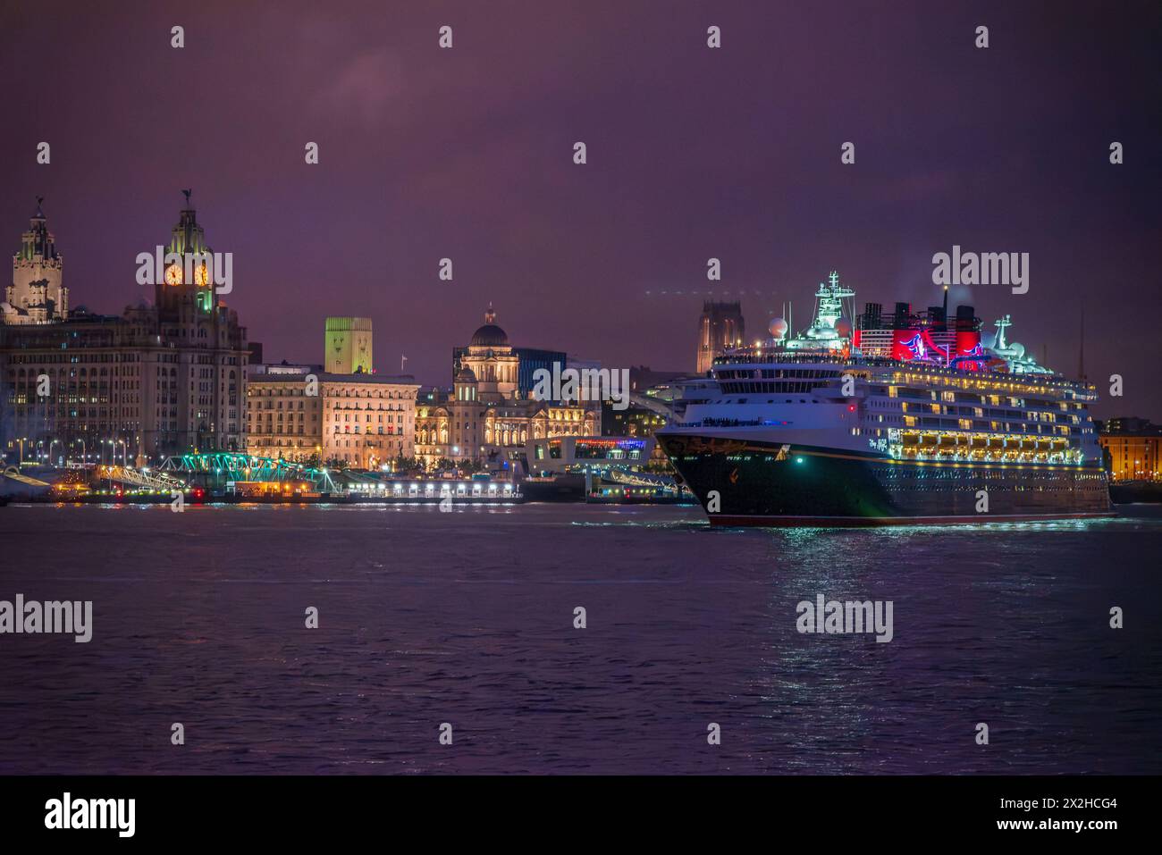 Das Disney Magic Kreuzfahrtschiff bei Nacht verlässt Liverpool mit Feuerwerk. Stockfoto