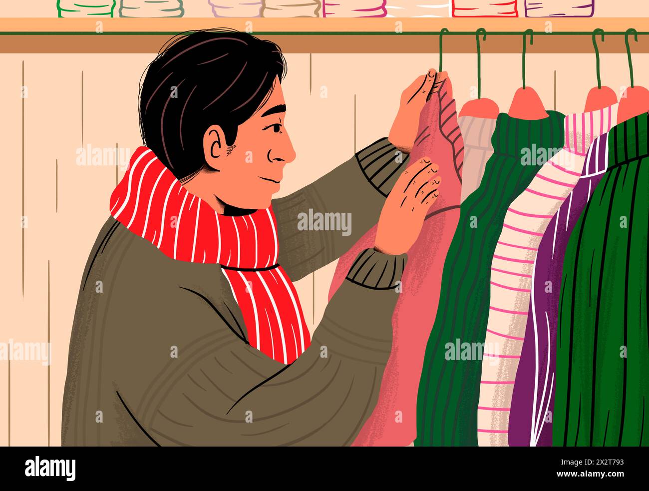 Mann mit gestreiftem Schal, der im Laden Pullover kauft Stockfoto
