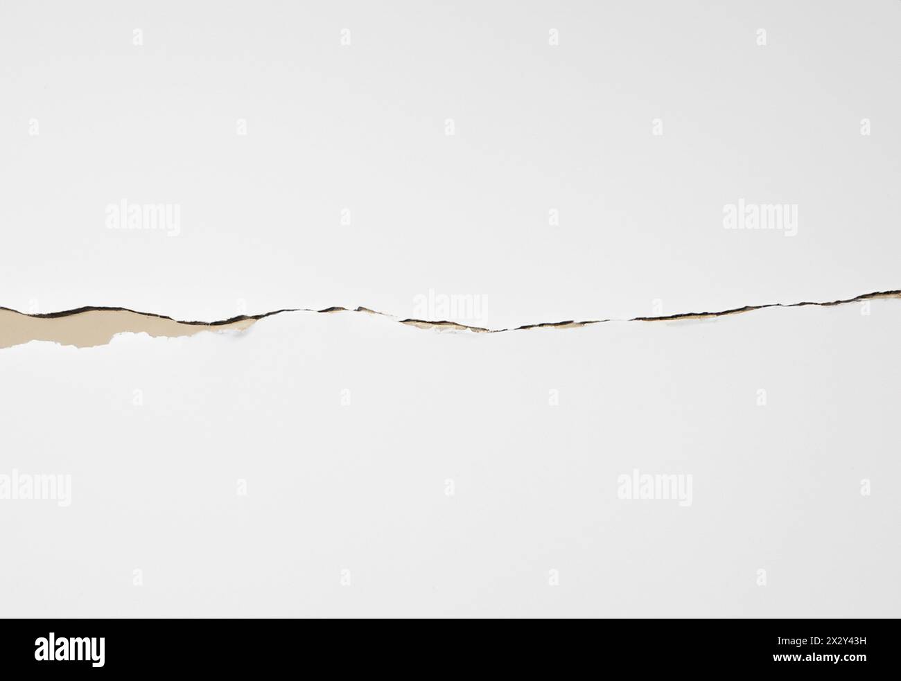 Horizontaler Einriss in einem Blatt weißes Papier Stockfoto