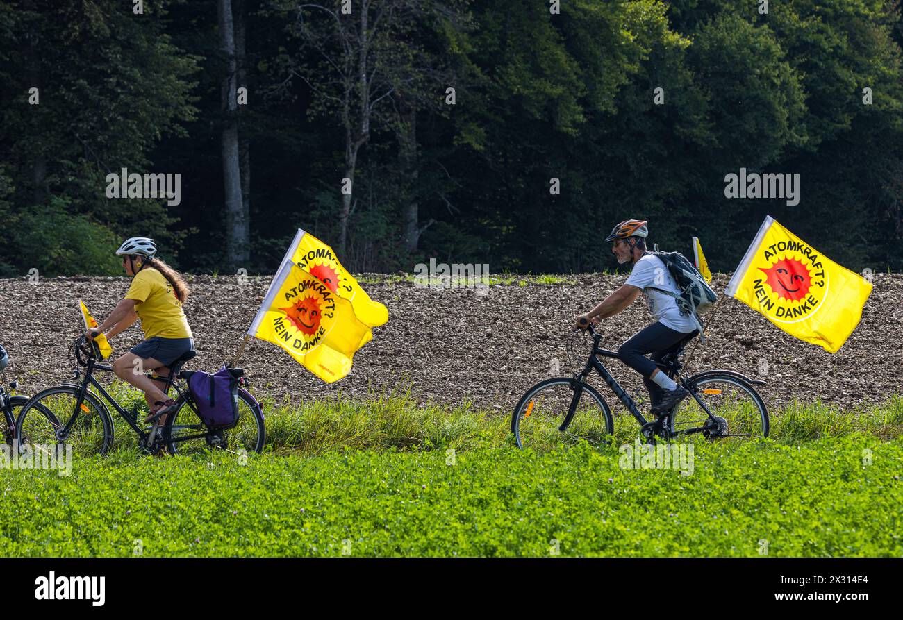 Atomkraftgegner sind mit dem Fahrrad und der Flagge der Bewegun unterwegs. (Marthalen, Schweiz, 30.08.2022) Stockfoto