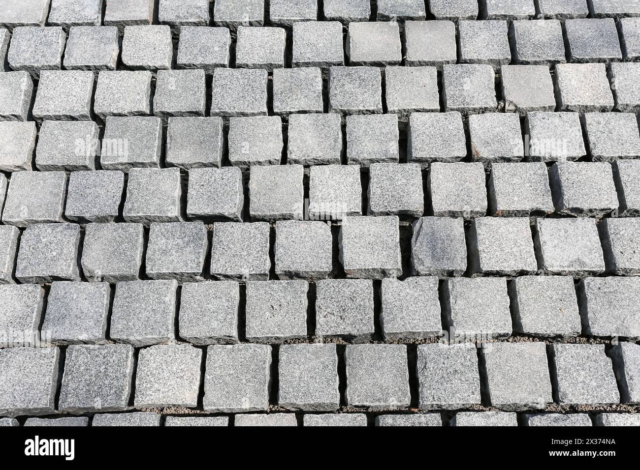 Hintergrund aus frisch gebliebenem Kopfsteinpflaster Stockfoto