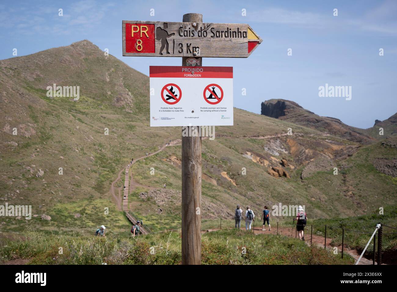 Wanderer und Wanderer treten am 17. April 2023 in Madeira, Portugal, auf einem gut markierten, aber erodierenden Cais de Sardinha-Wanderweg mit Blick auf die Baia d'Abra am äußersten östlichen Ende der portugiesischen Insel Madeira. Stockfoto