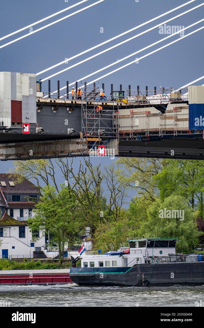 Die neue Rheinbrücke Neuenkamp, die A40, die weißen Säulenseile und die alte Autobahnbrücke, die im Abriss steht, die Arbeiter, die den Abriss vorbereiten, Stockfoto