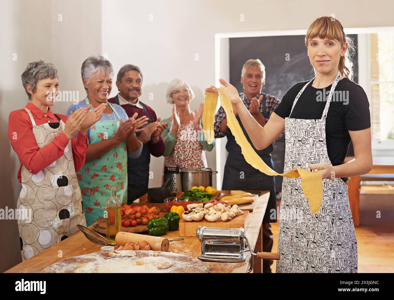 Kochkurs, Pasta und Porträt von Menschen in der Küche, die Rezepte für Küche, kulinarische Fähigkeiten und Kochkunst lernen. Feier, Applaus und glückliche Männer und Stockfoto