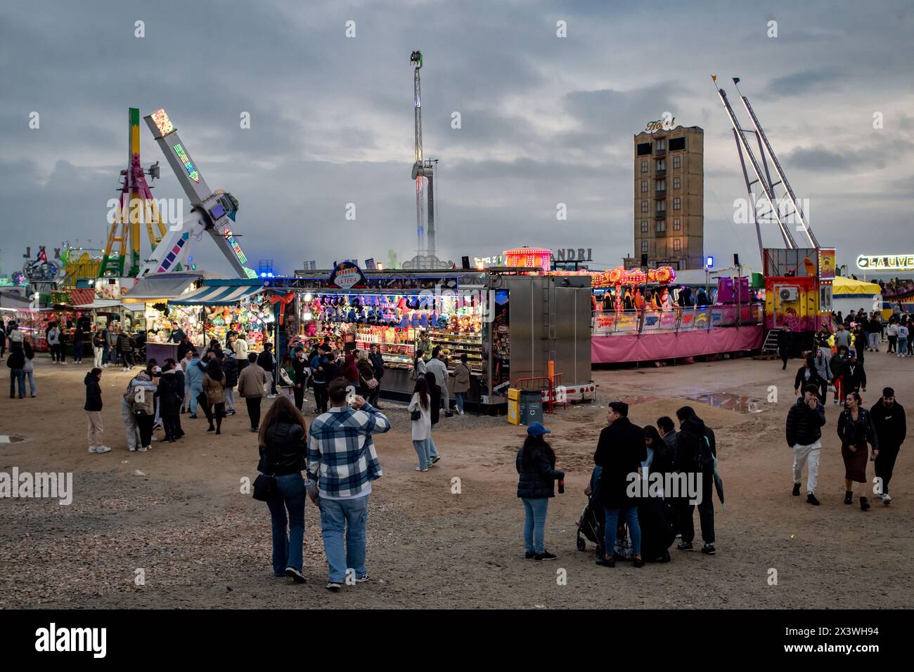 Besucher besuchen einen Vergnügungspark im Parc del Forum von Barcelona anlässlich der Feierlichkeiten der Aprilmesse (Feria de Abril). Die Feria de Abril in Barcelona ist ein Volksfest andalusischer Wurzeln, das seit fast 50 Jahren in Katalonien gefeiert wird. Stockfoto