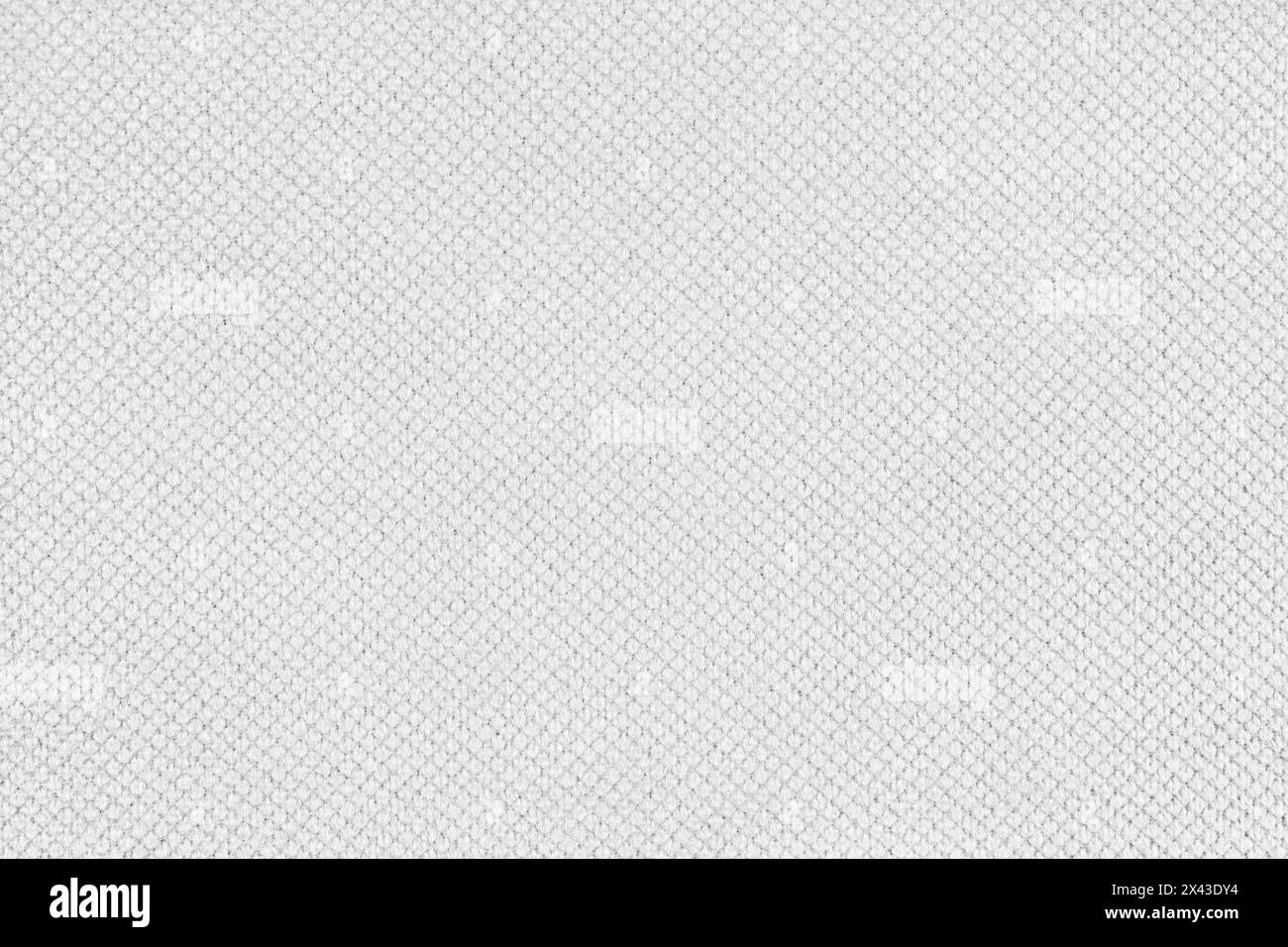 Einfarbiges weißes Velourspolster, Jacquard mit feinem Rautenhintergrund. Nahaufnahme, Textiloberfläche aus Makrogewebe. Tapete, Hintergrund mit Co Stockfoto