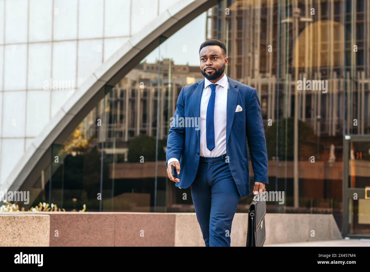 Schwarzer Mann im Anzug aus dem Büro mit seiner Aktentasche Stockfoto