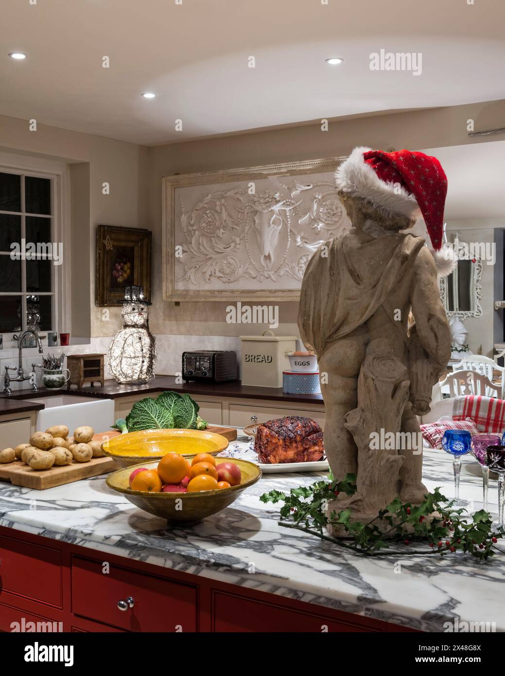 Statue in santa Hut auf Kücheninsel mit Essen in Dorset Familienheim zu Weihnachten, England, Großbritannien Stockfoto