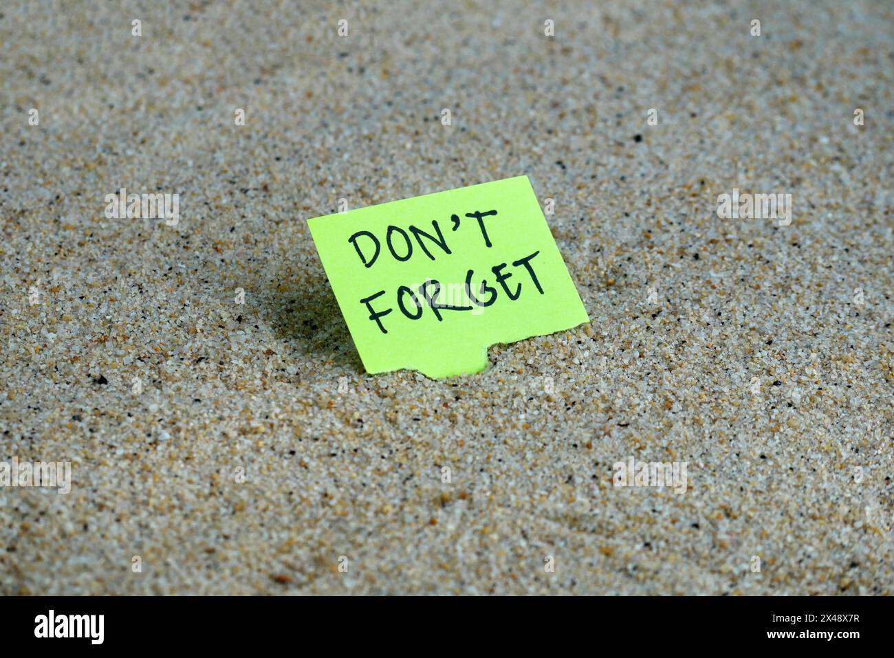 Grüne Haftnotizen mit Wort, vergessen Sie nicht auf Sand Stockfoto Grüne Haftnotizen mit Wort, vergessen Sie nicht auf Sand Stockfoto
