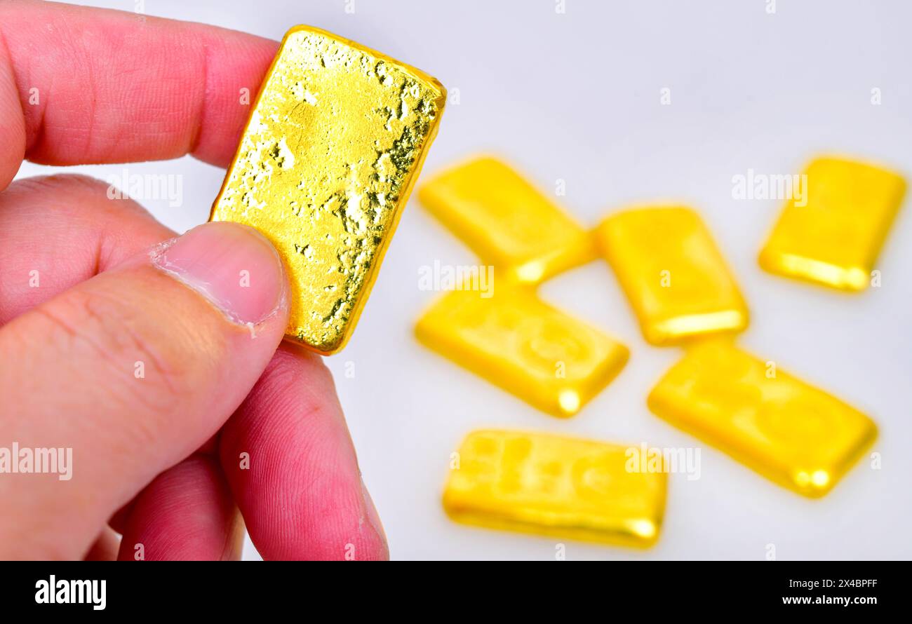 Nahhand mit Goldbarren isoliert auf weißem Hintergrund Stockfoto