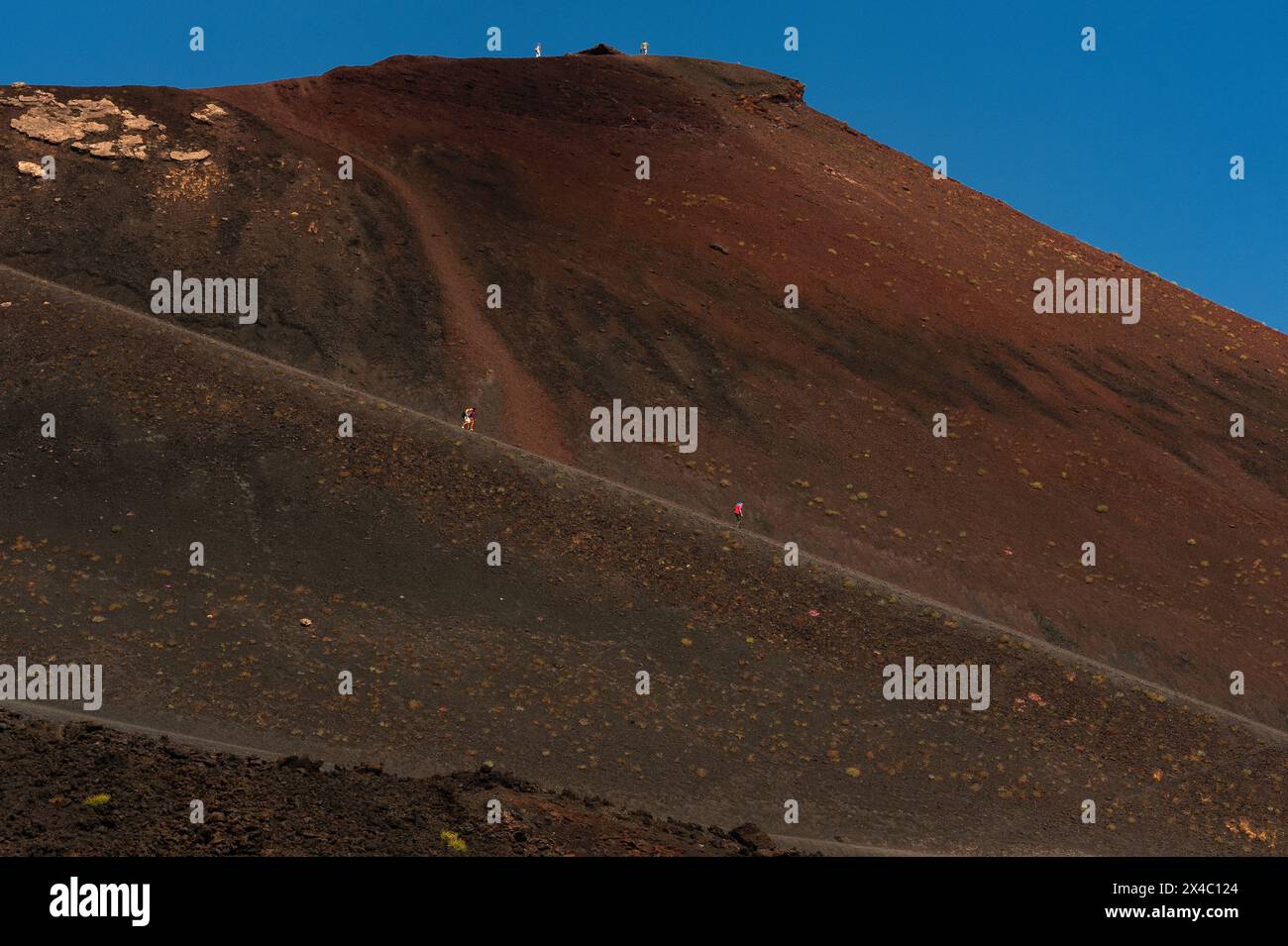 Touristen schlendern die lange, von Menschenhand geschaffene Rampe auf dem Ätna in Sizilien, Italien. Die Rampe führt zum Rand eines erloschenen Kraters, der den Gipfel umgibt. Stockfoto