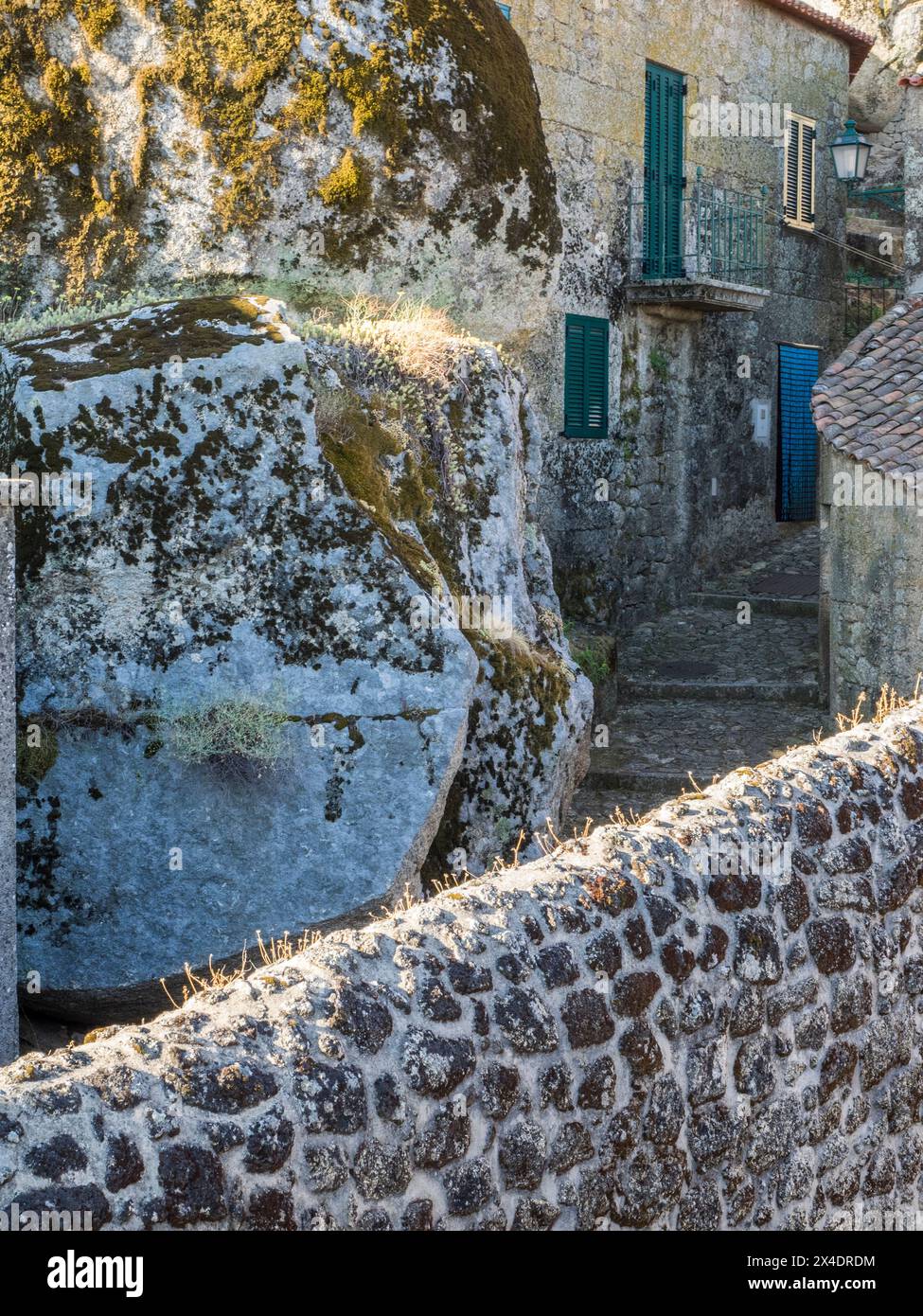 Altes portugiesisches Dorf, das auf der Seite eines Berges zwischen großen Felsbrocken mit Kopfsteinpflasterstraßen und Häusern erbaut wurde. Stockfoto