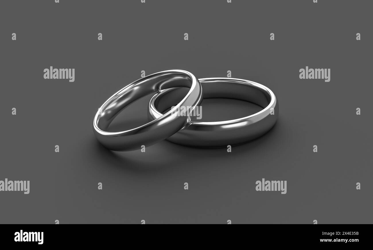 Illustration von zwei silbernen Eheringen auf dunklem Hintergrund. Einheit und Liebe Konzept Stockfoto