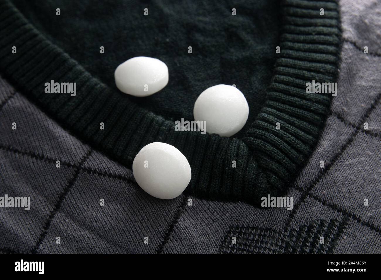 Weiße Naphthalinkugeln auf Tuch. Stockfoto