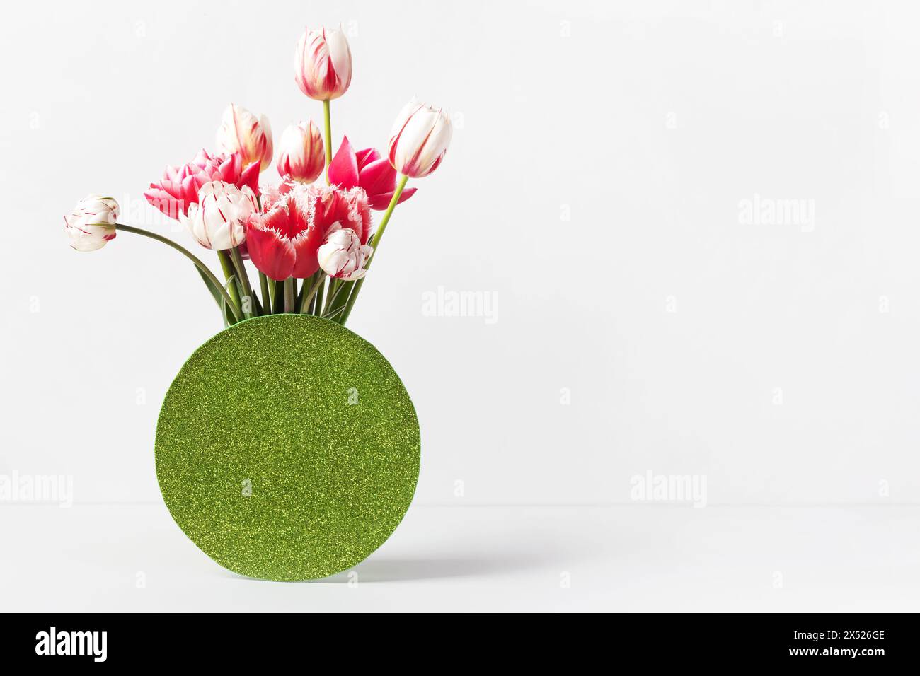 Pinkfarbene und weiße Tulpen in einer Vase auf einem Tisch mit Platz für Text. Grußkarte zum Muttertag, Happy Valentine's Day, 8. März, Happy birthday Stockfoto
